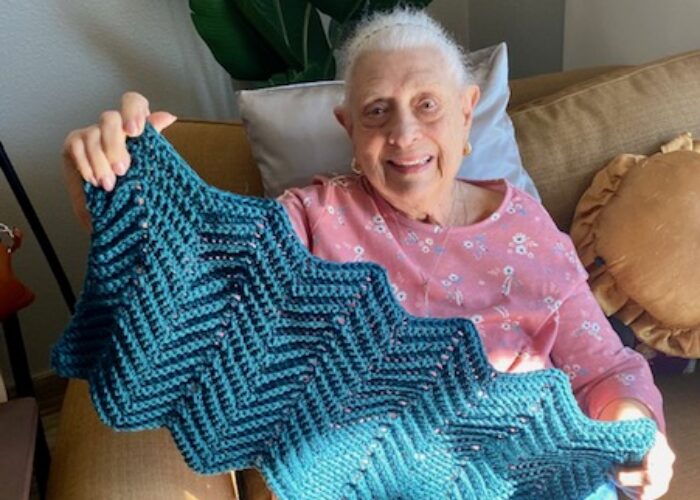 Sandy making a cat blanket to be donated to animal shelter